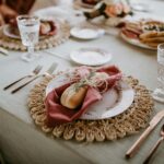 High angle of loaf tied with napkin and sprig of rosemary on served table at wedding celebration